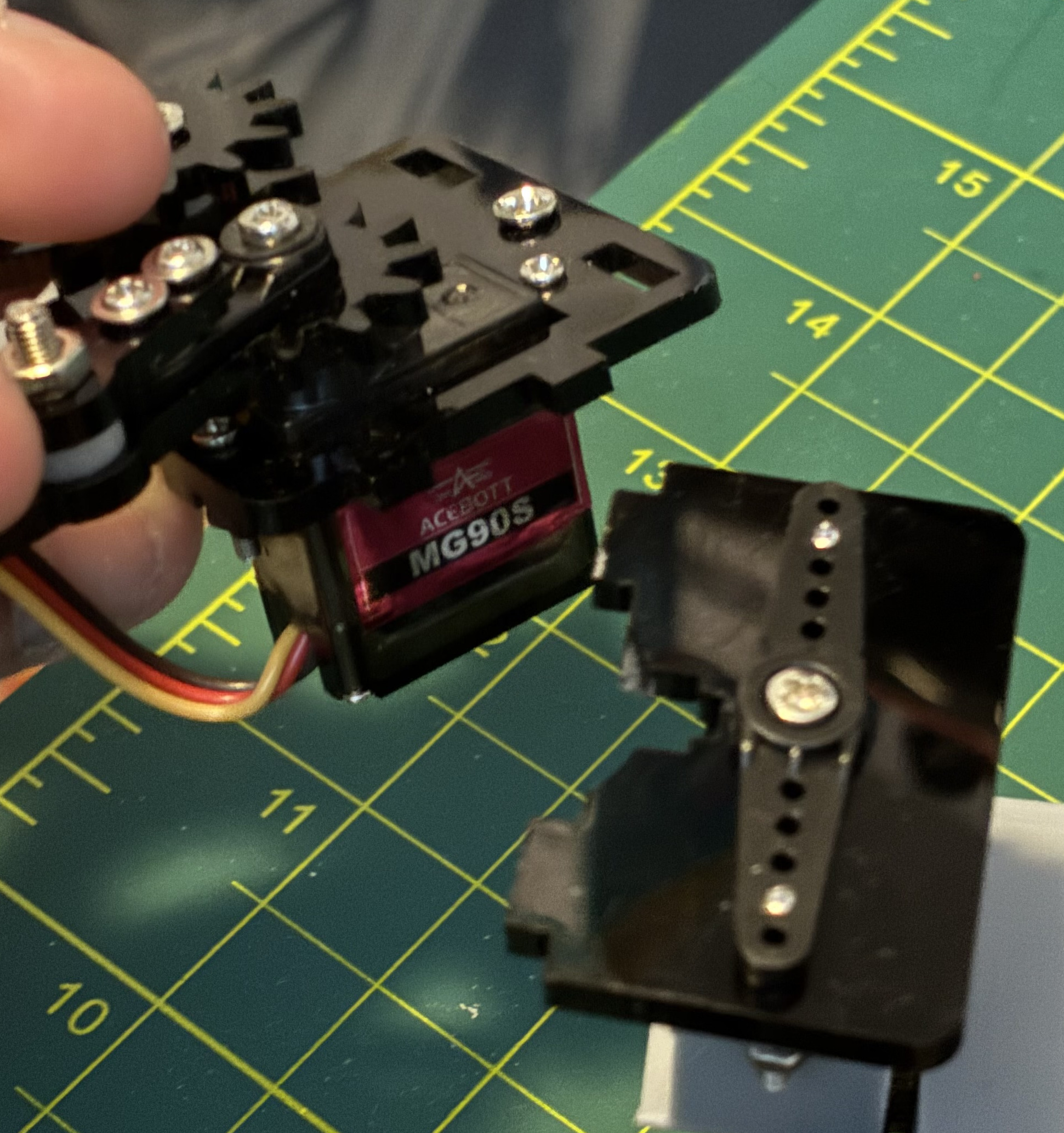 The broken gripper after falling off the desk.